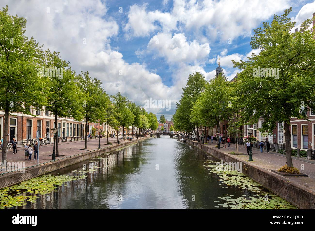 Visitors walking along Rapenburg canal during the Rembrandt van Rijn festival in Leiden, South Holland, Netherlands. Stock Photo