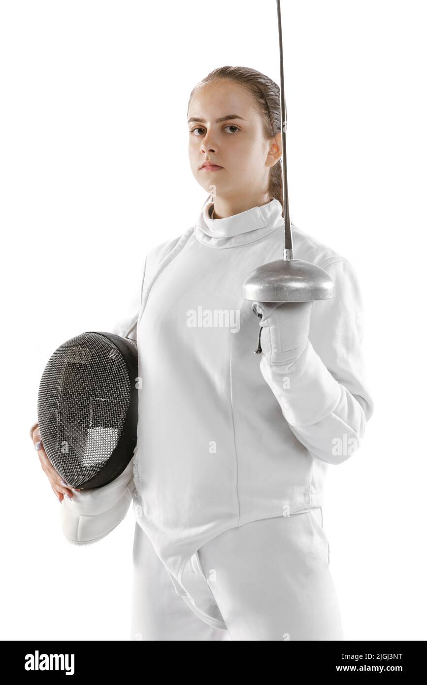 Young girl, fencer in white fencing costume posing with rapier isolated