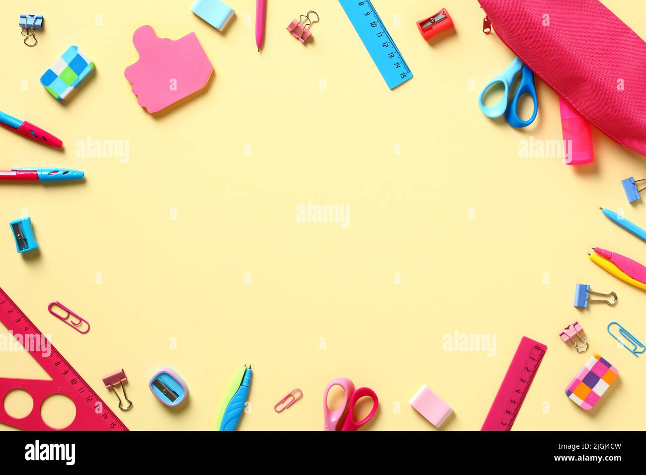 Back to school concept. Frame made of school supplies on yellow table ...