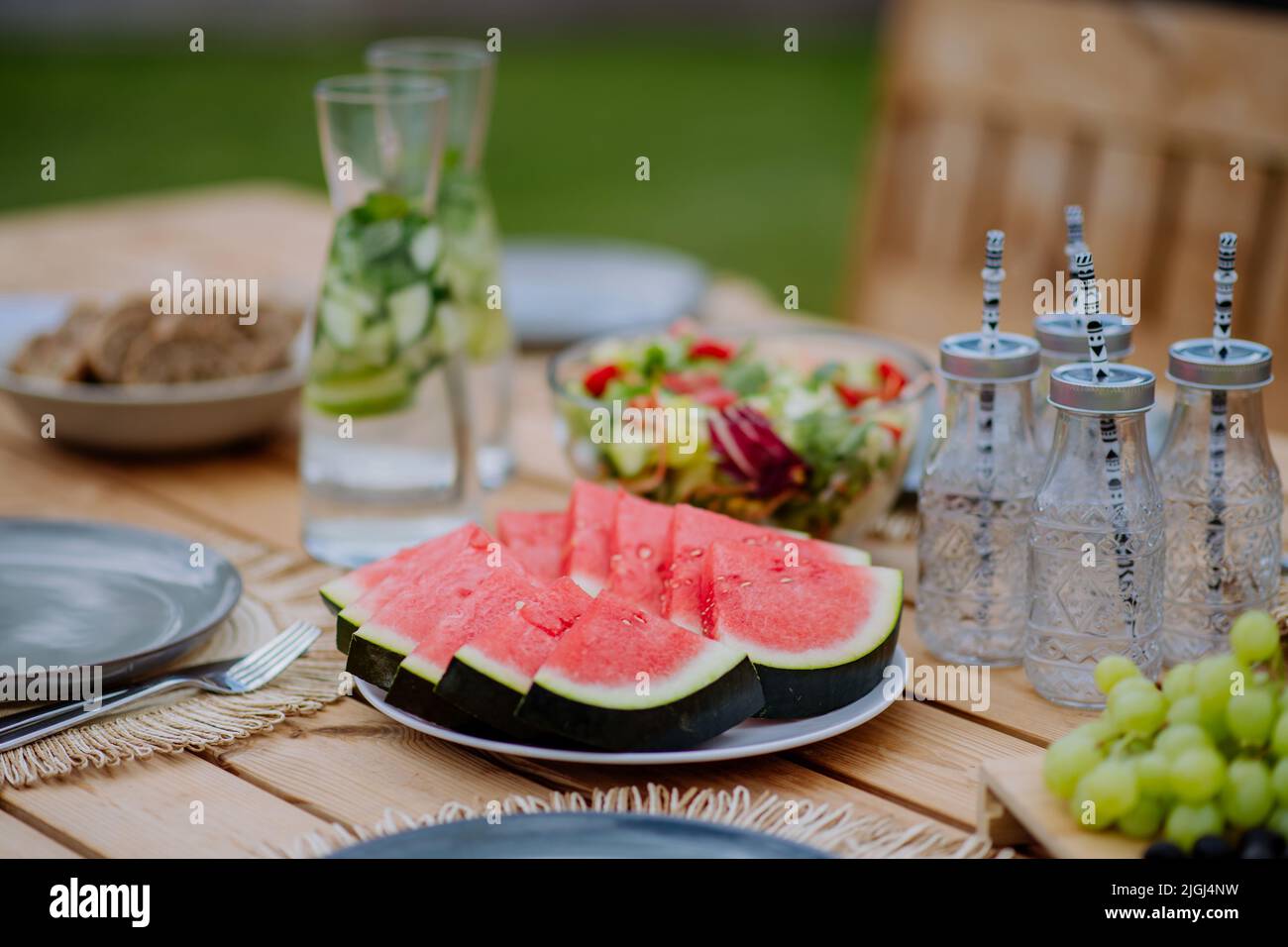 Dining table set for dinner on the terrace in summer, garden party concept. Stock Photo