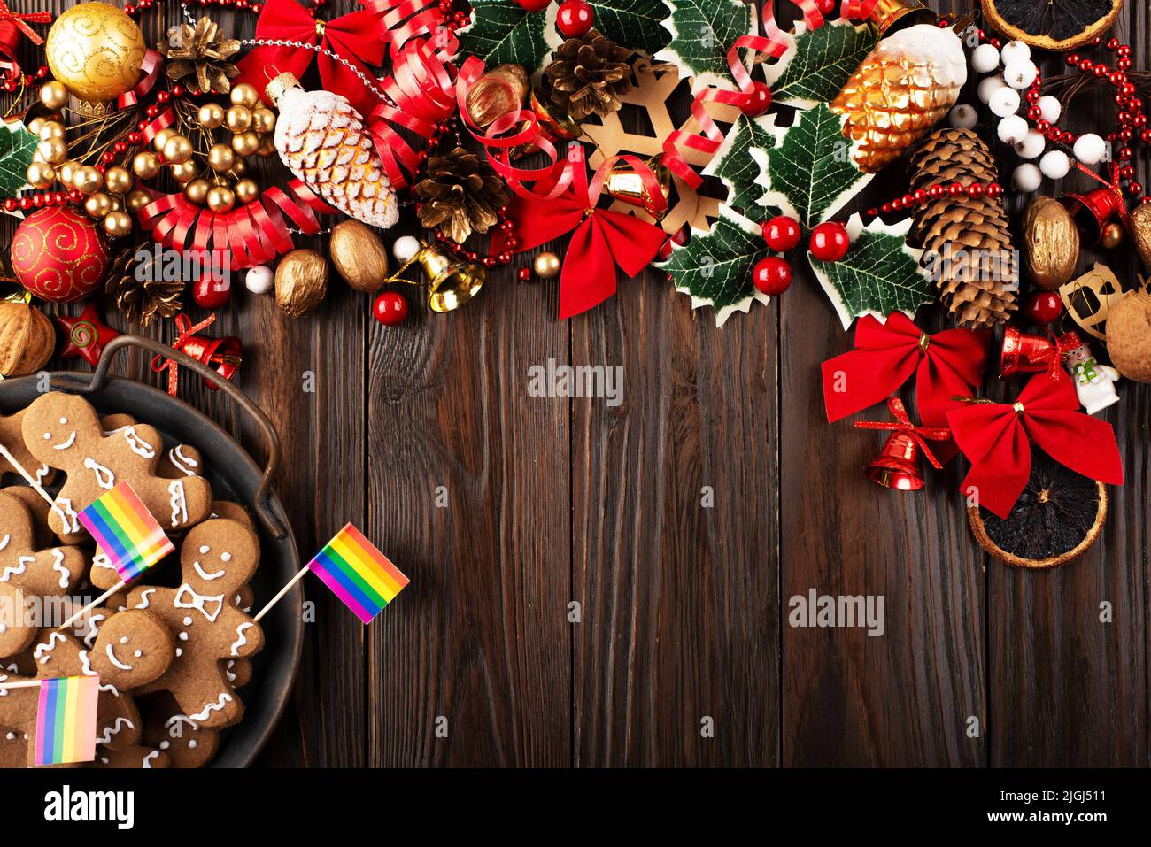 Christmas background of tray with gingerbread cookie men and rainbow flags on wooden table Stock Photo