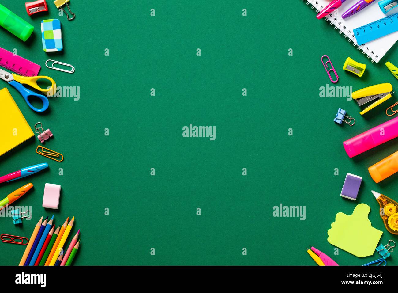 Back to school concept. Frame made of colorful school supplies on green ...