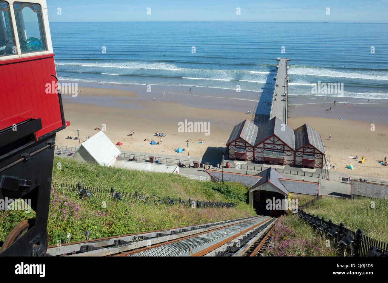 View from the top station of the Saltburn Hydraulic Funicular cliff lift looking down to the pier ready to move off Stock Photo