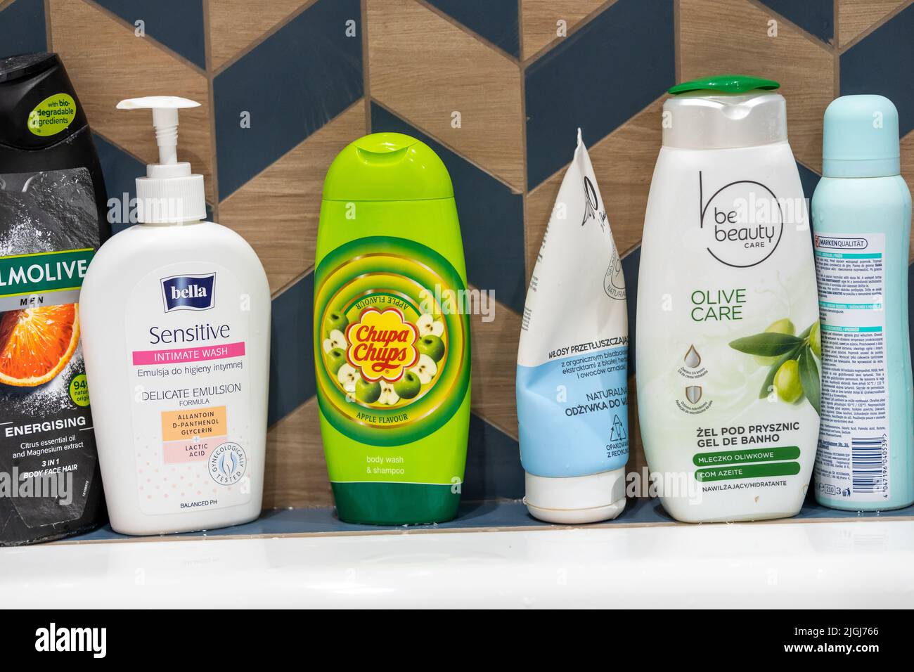 A row of shampoos and shower gel bottles including Be Beauty and