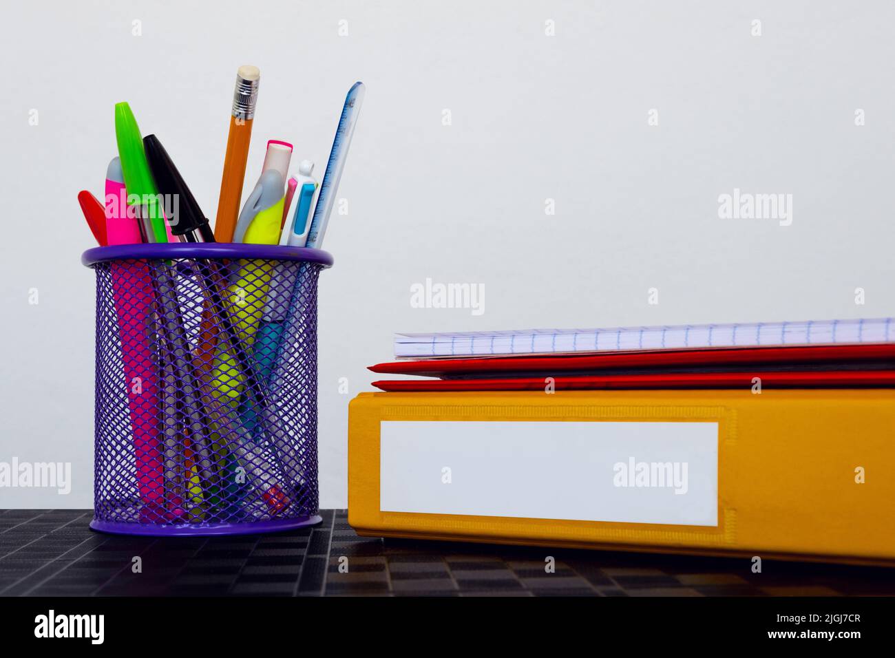 School folders and stationery on white background with copy space