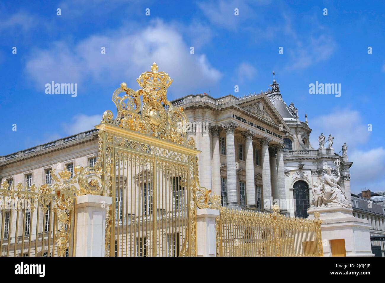 Gilded gate with crown, entrance to the former royal palace at Versailles Stock Photo