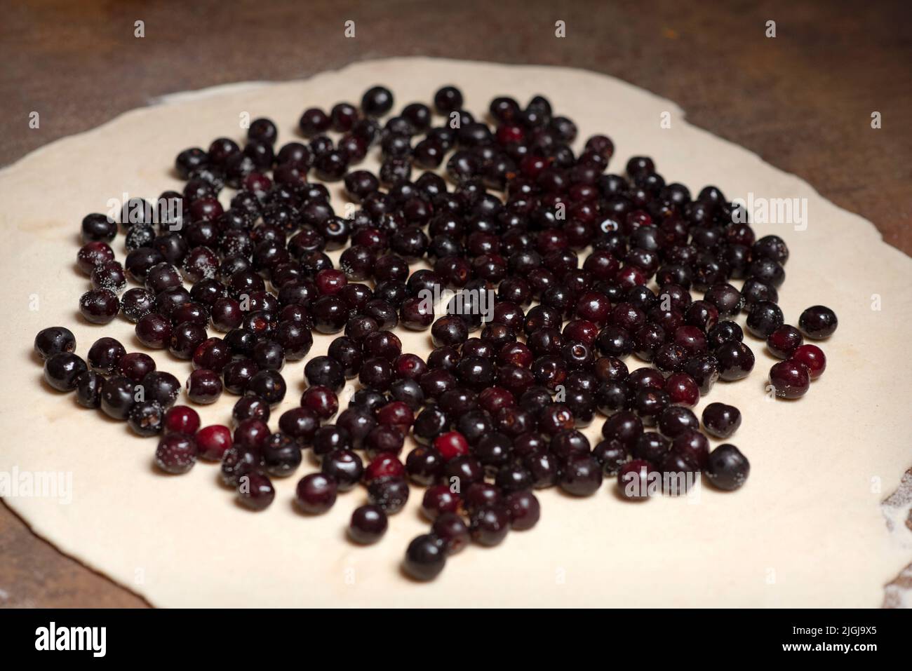Process of preparing pie with wild cherry - a moldavian traditional summer dish Stock Photo
