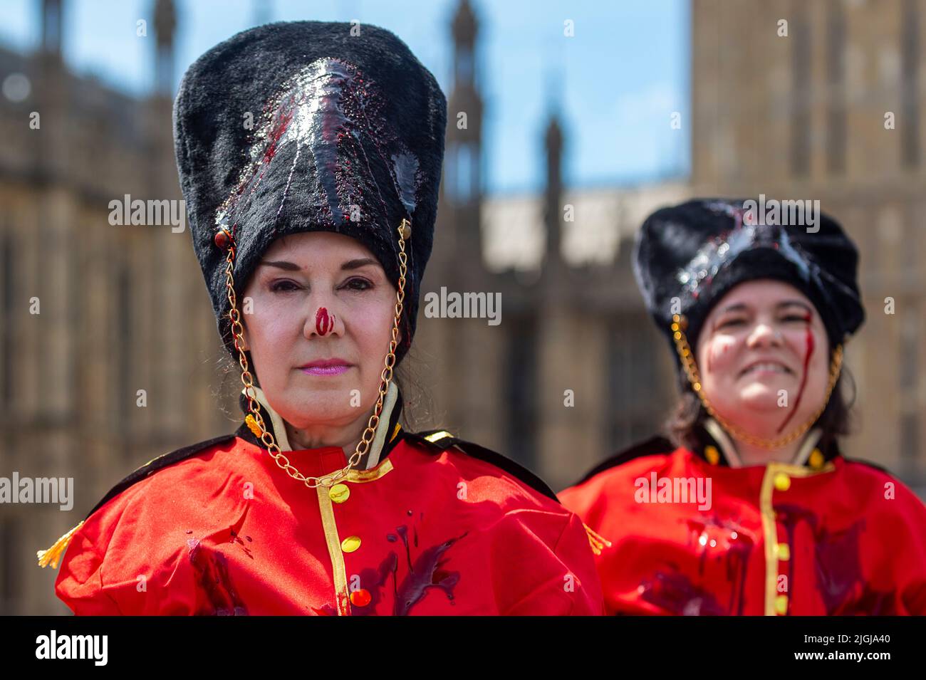 London, UK.  11 July 2022.  Members of PETA (People for the Ethical Treatment of Animals) stage a stunt on Westminster Bridge dressed as Queen’s Guards covering themselves in fake blood.  The stunt is ahead of a debate in Parliament in which MPs will discuss replacing the bearskins used for the Queen’s Guard’s caps with faux fur.  Credit: Stephen Chung / Alamy Live News Stock Photo