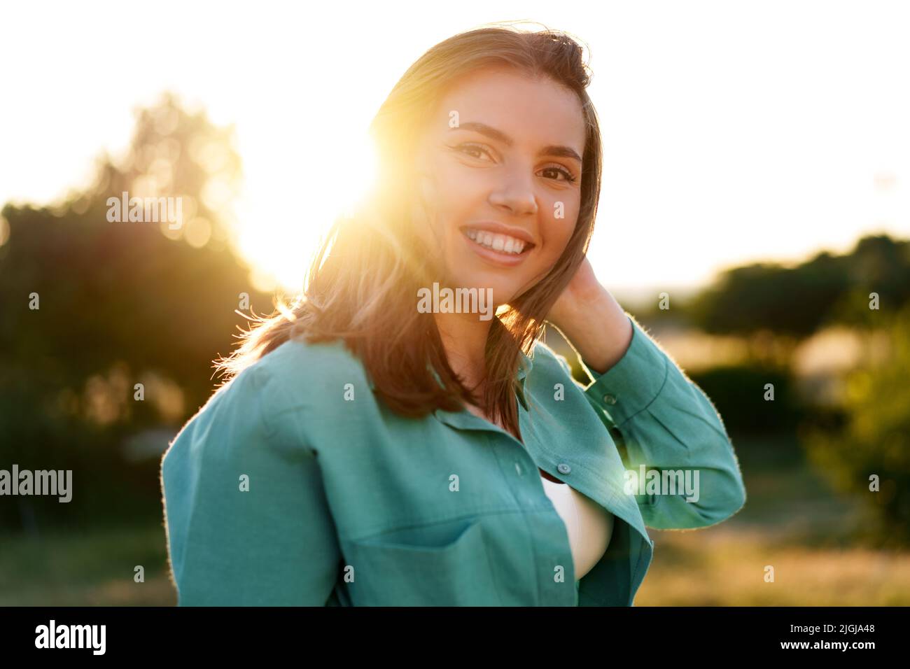 Close up portrait of a young smiling brunette woman Stock Photo - Alamy