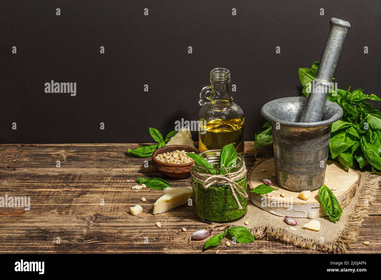 Homemade Italian basil pesto sauce in a vintage mortar with pestle