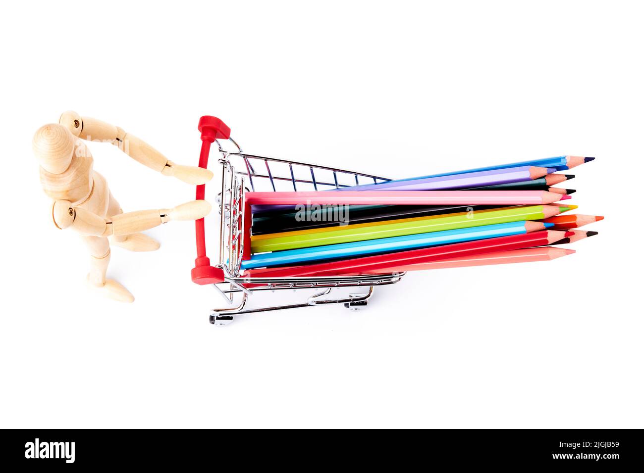 Dummy pushing a shopping cart with some multi-colored pencils. Art school concept. Studio concept Stock Photo