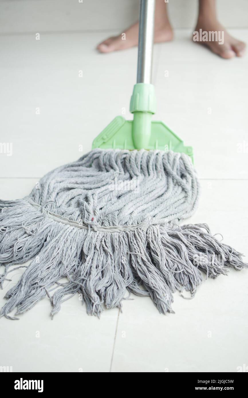 cleaning tiles floor with mop Stock Photo Alamy