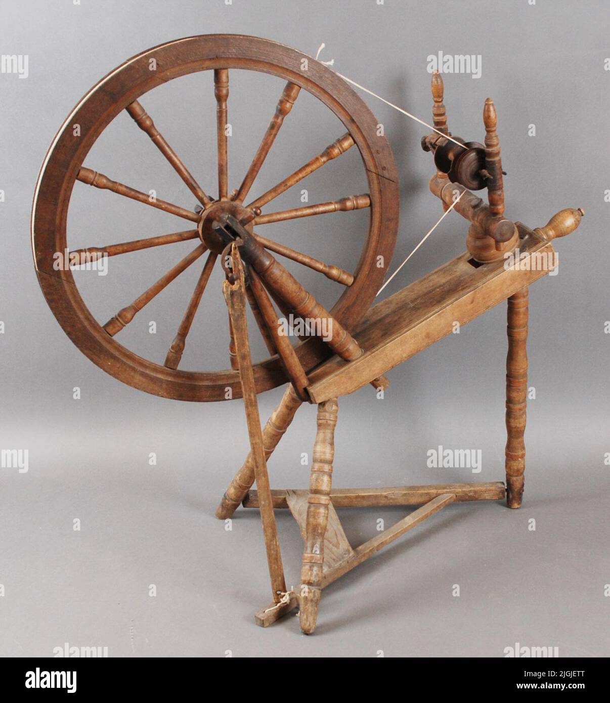 Spinnrock Spinning coat in dark stained wood. Tagged "isg" on the top. The tramp stitch up to the drive wheel is broken. Previous acquisitions, unmarked. Stock Photo