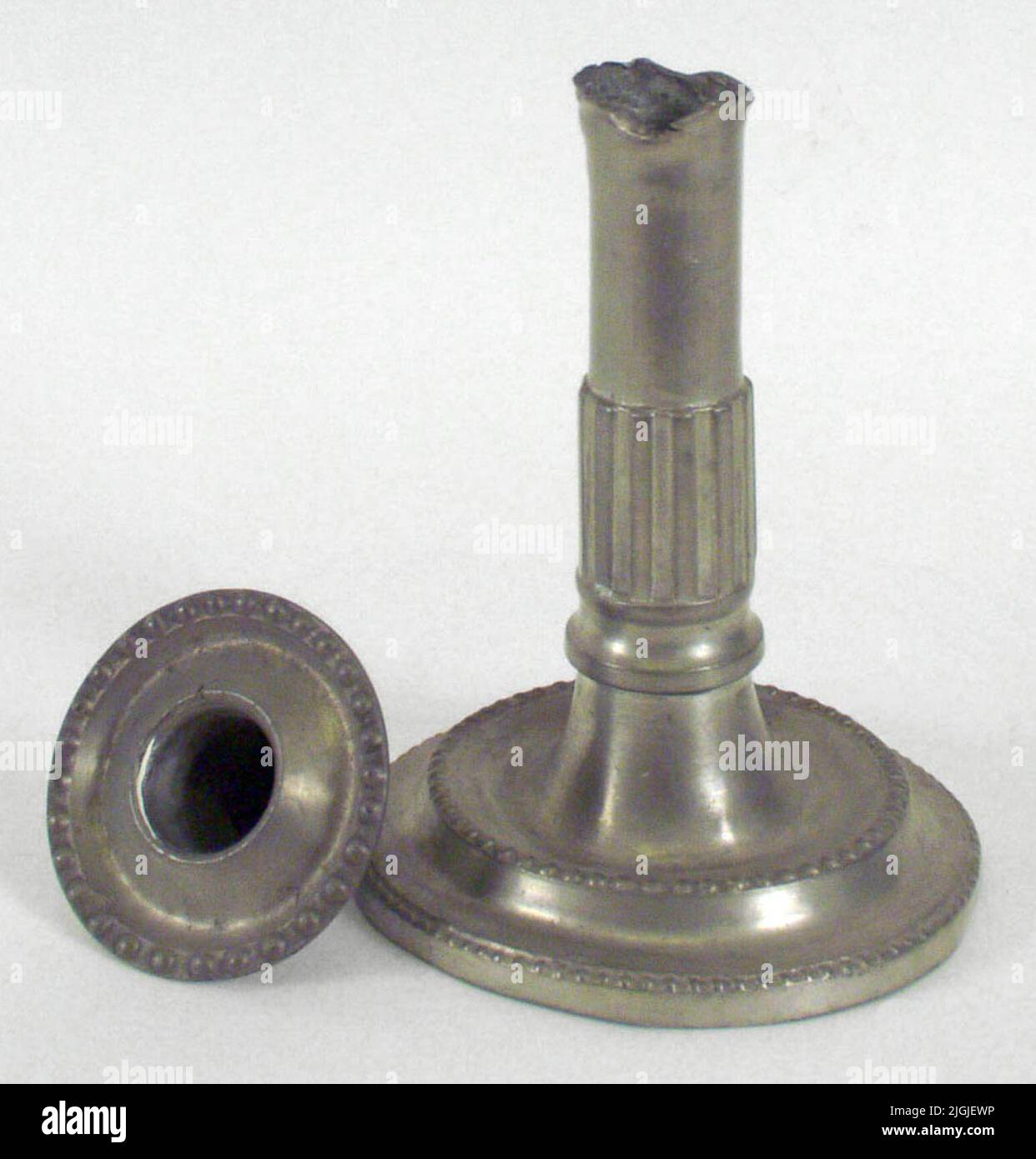 Ljusstake Candlestick of tin, Gustavian. Round foot, profiled with pearl bar ornaments at both profile edges. Cylindrical shaft with a lot of wide grooves. Light cuff fitted with sparse pearl bar. Stamps: Karlskrona city weapons and two master stamps consisting of a ship inside a shield and around the mast the letters AE. The yearbook Stave G2. Made by Andreas Ekman 1789. Operated in Karlskrona 1798-1800. Stock Photo