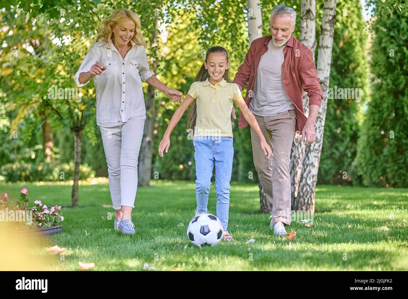 Happy family playing football in the park Stock Photo - Alamy