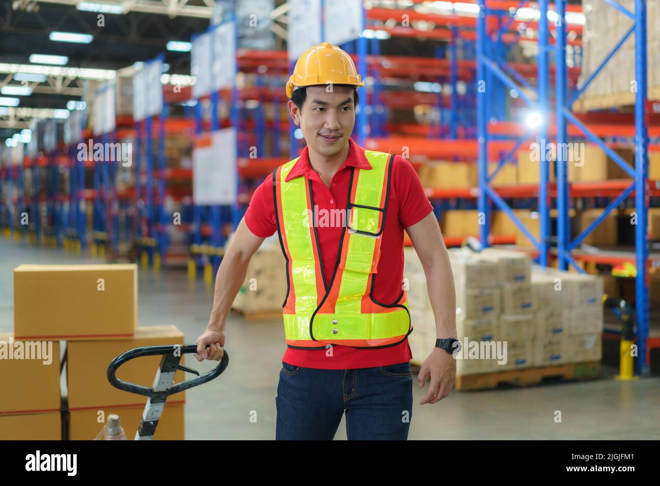 Shipping boxes. Asian man Warehouse worker unloading pallet shipment goods into a truck container, warehouse industry freight, logistics and transport Stock Photo