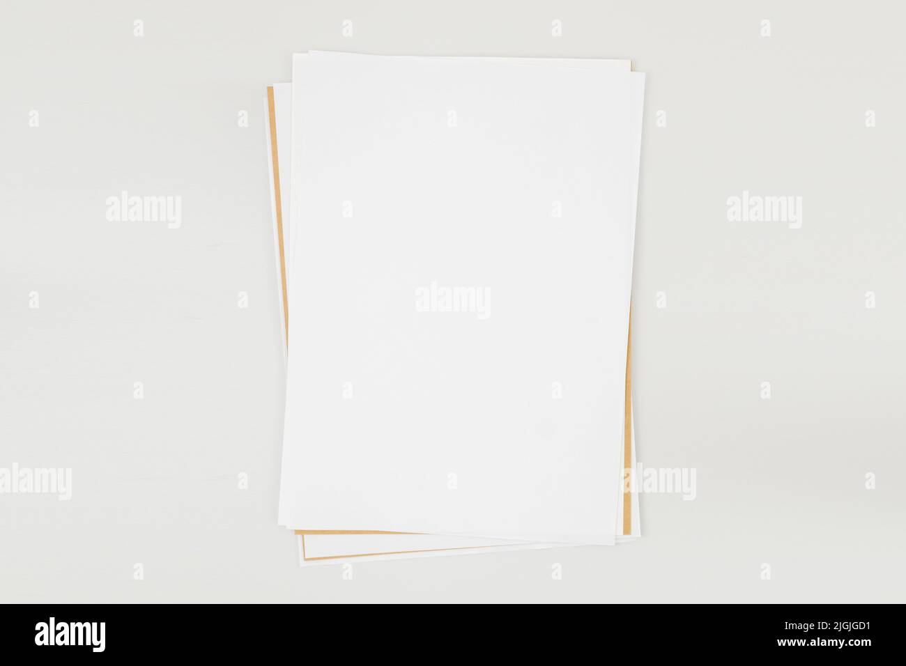 Sheets of white and craft paper A4 or A5 with shadows isolated on a white background. Book pages lying on the table top view. Concept for the banner Stock Photo