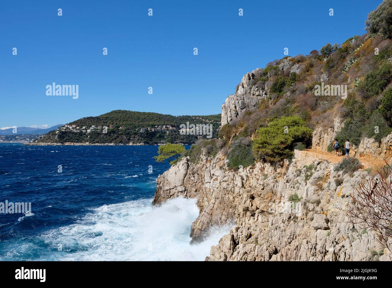 Person hiking around St-Jean-Cap-Ferrat with rocky coast on Cote D'Azure near Nice Stock Photo