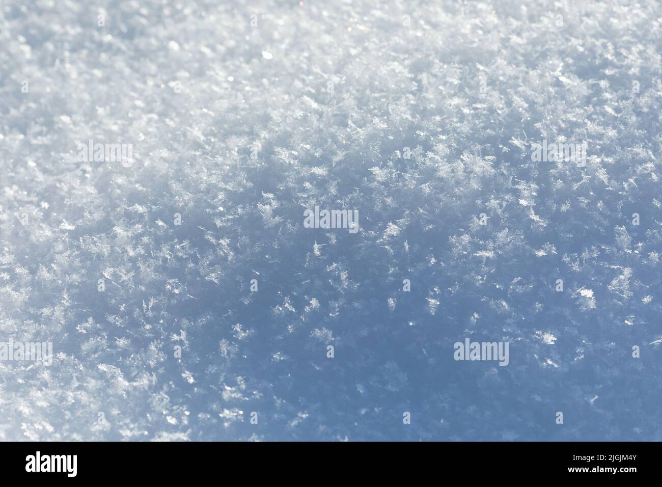 Macro view snow texture background with shadows. Winter season decorative nature frame. Ground surface covered crystal snowflakes after snowfall Stock Photo