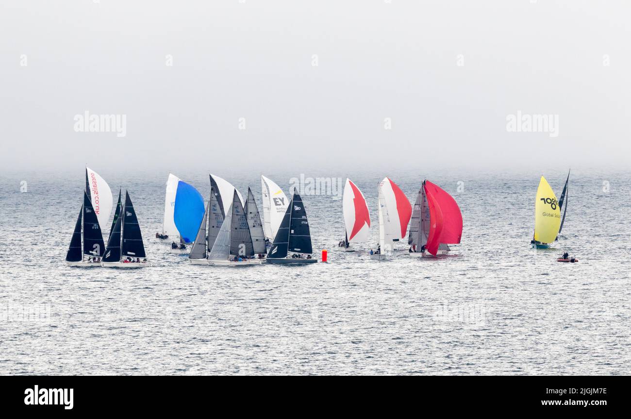 Crosshaven, Cork, Ireland. 11th July, 2022. With fog beginning to lift on the first day of Volvo Cork Week, yachts begin to race in full sail  outside Roches Point in Co. Cork, Ireland. - Credit; David Creedon / Alamy Live News Stock Photo