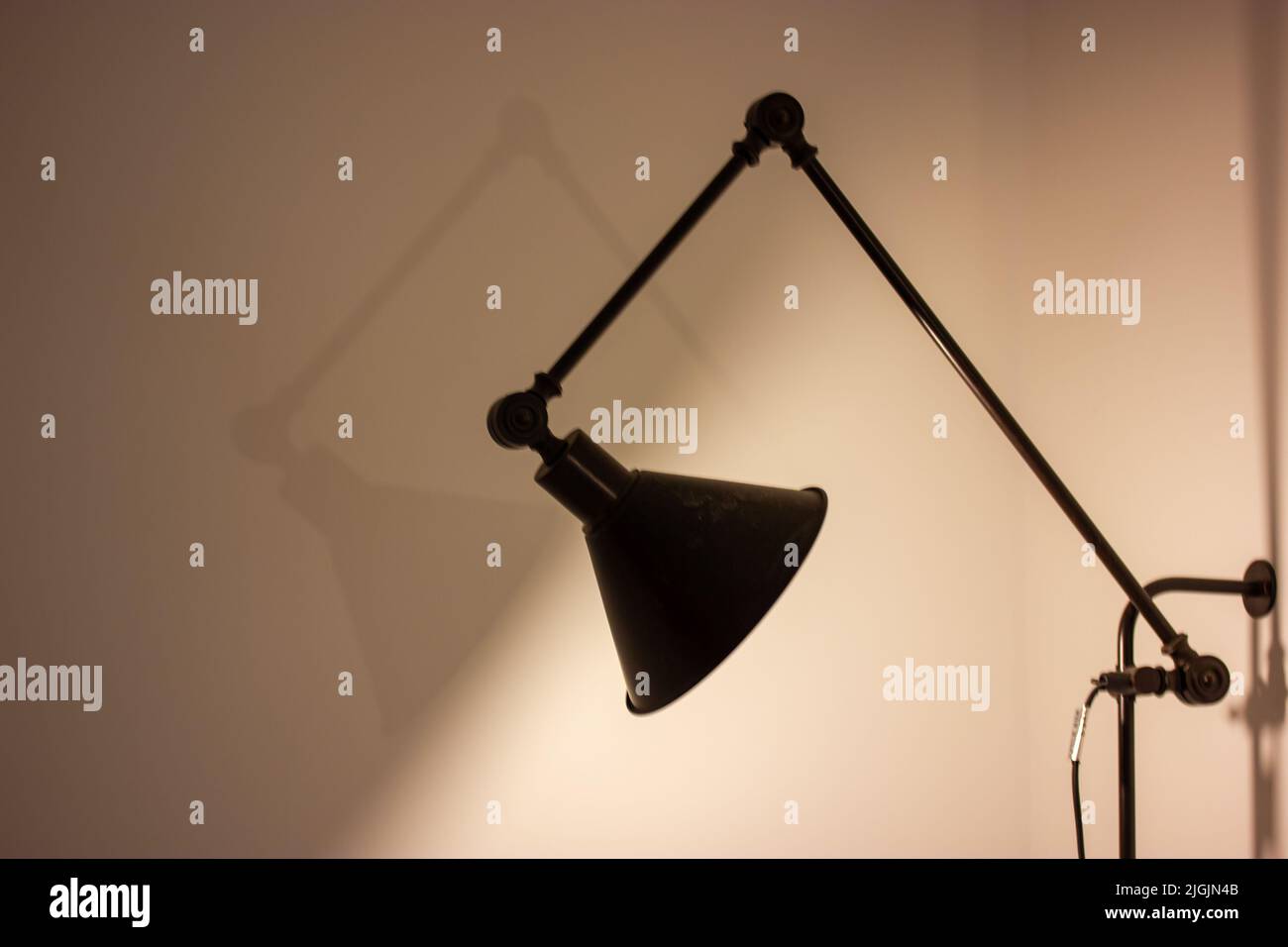 Bedside lamp in dark room. Stylish modern home interior light fixture