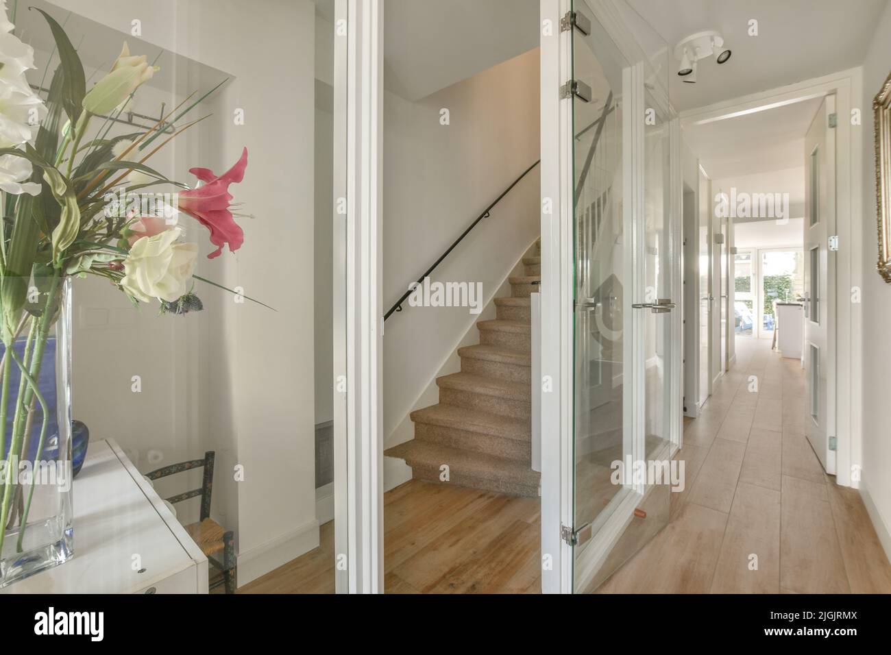 White hallway with wooden stairway leading to second floor of modern ... - Small Penthouse Apartment With Minimalist Hallway