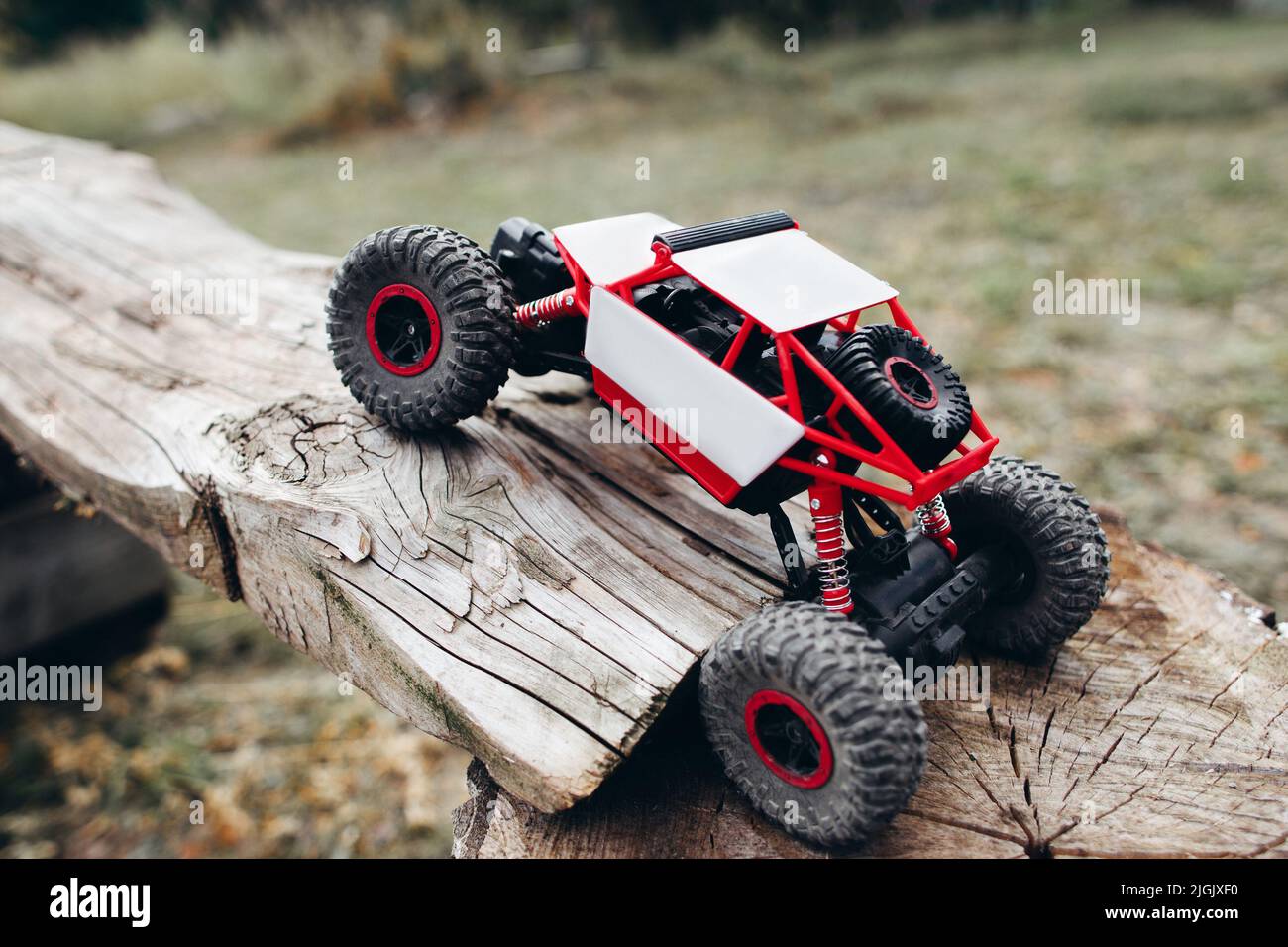 Rc car overcoming wooden log, free space Stock Photo