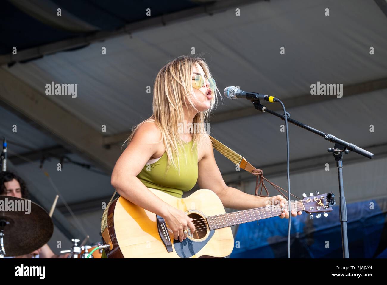 NEW ORLEANS, LA, USA - MAY 1, 2022: Maggie Koerner plays guitar and sings at the 2022 New Orleans Jazz and Heritage Festival Stock Photo