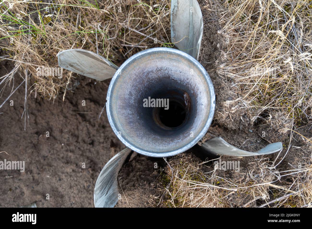 BM-30 Smerch missile stuck in the ground. A rocket was fired by the Russian army at a Ukrainian city. Russian war against Ukraine. Genocide of the Ukr Stock Photo