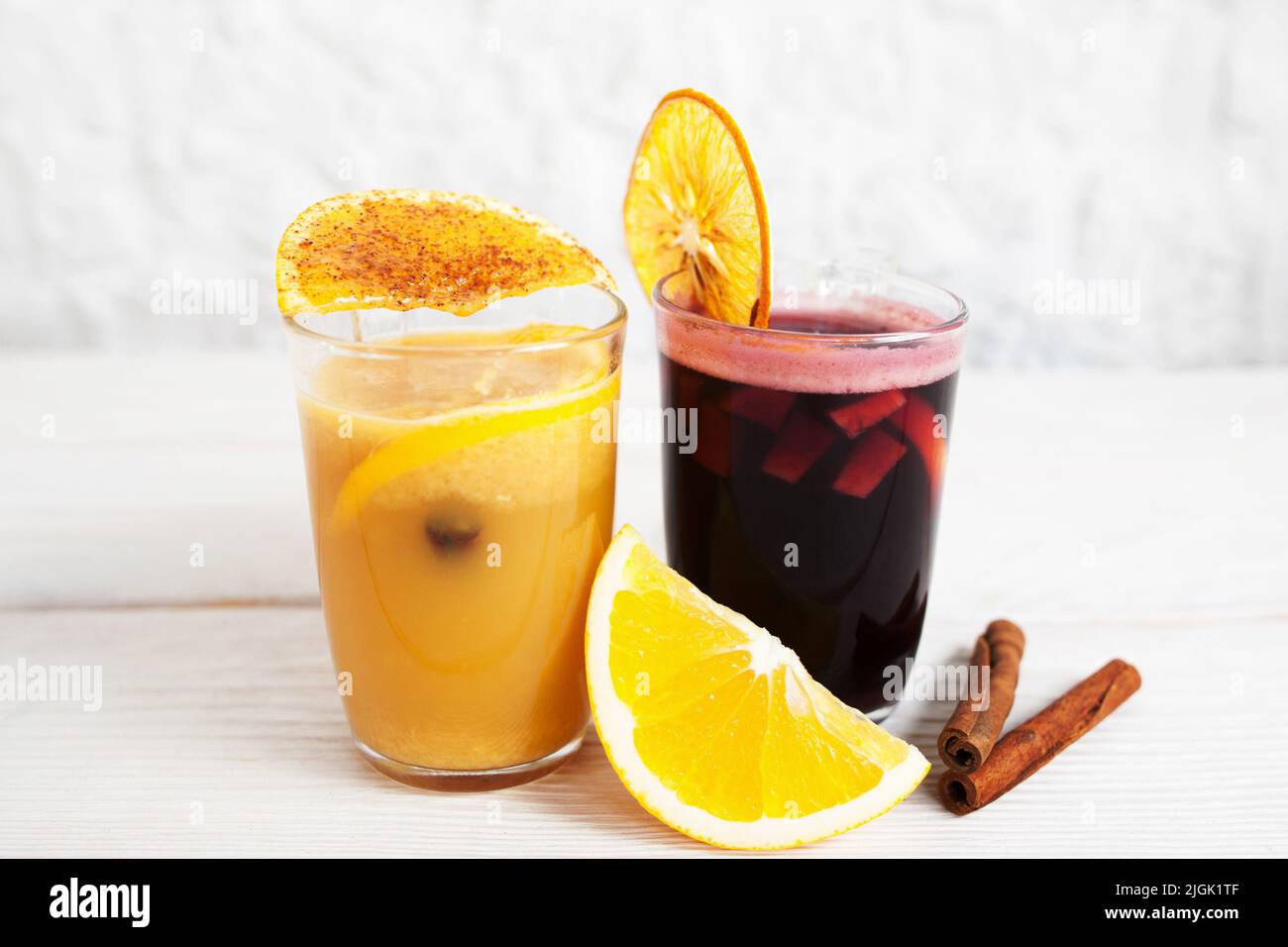 Punch and orange juice glasses on white background Stock Photo Alamy