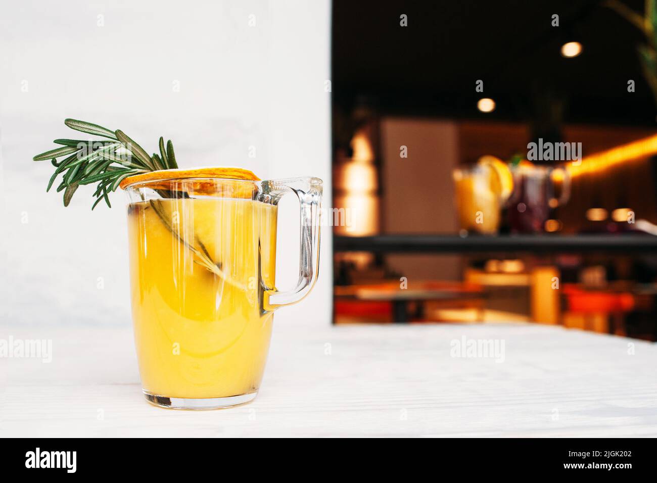 Orange juice with rosemary on cafe background Stock Photo Alamy