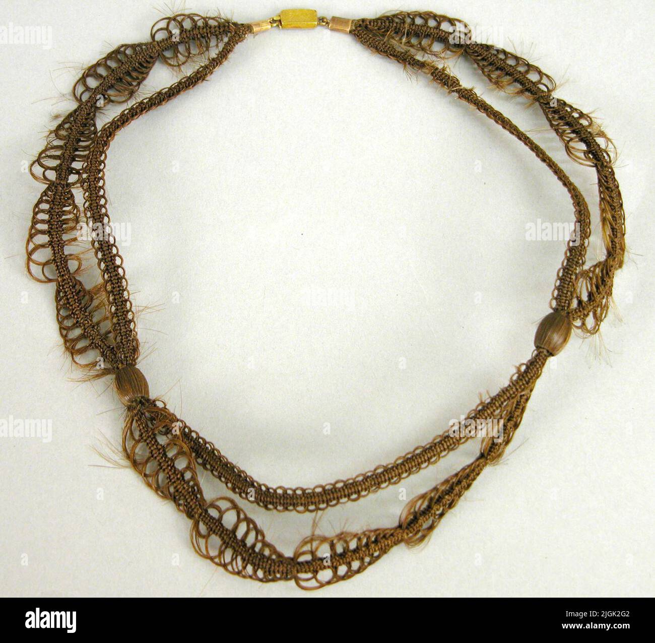 Halsband Necklace of brown hair. Two-row, a row shorter than the other in S-bows. The rows cohesive with two hair -clad bullets. Rectangular lock engraved in l alternatively J L. 19th century. Stock Photo