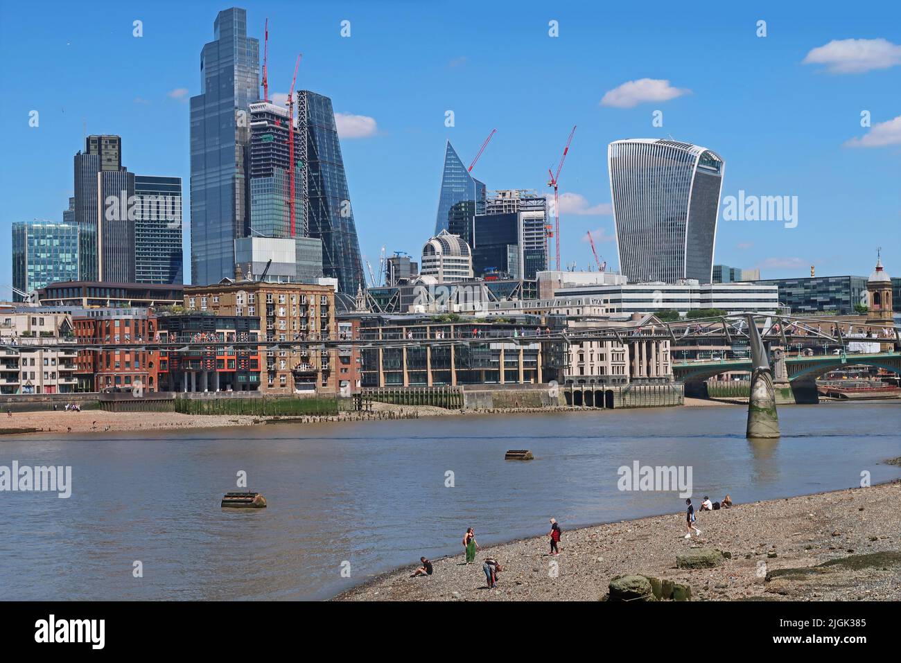 City of London skyline - July 2022. Viewed from the south bank of the River Thames at low tide. Stock Photo