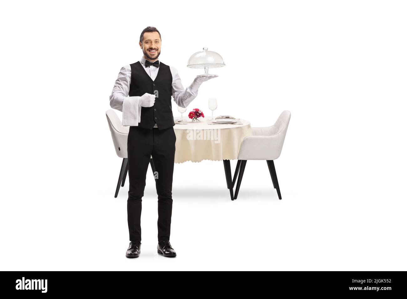 Waiter holding an empty cake plate in front of a table isolated on white background Stock Photo