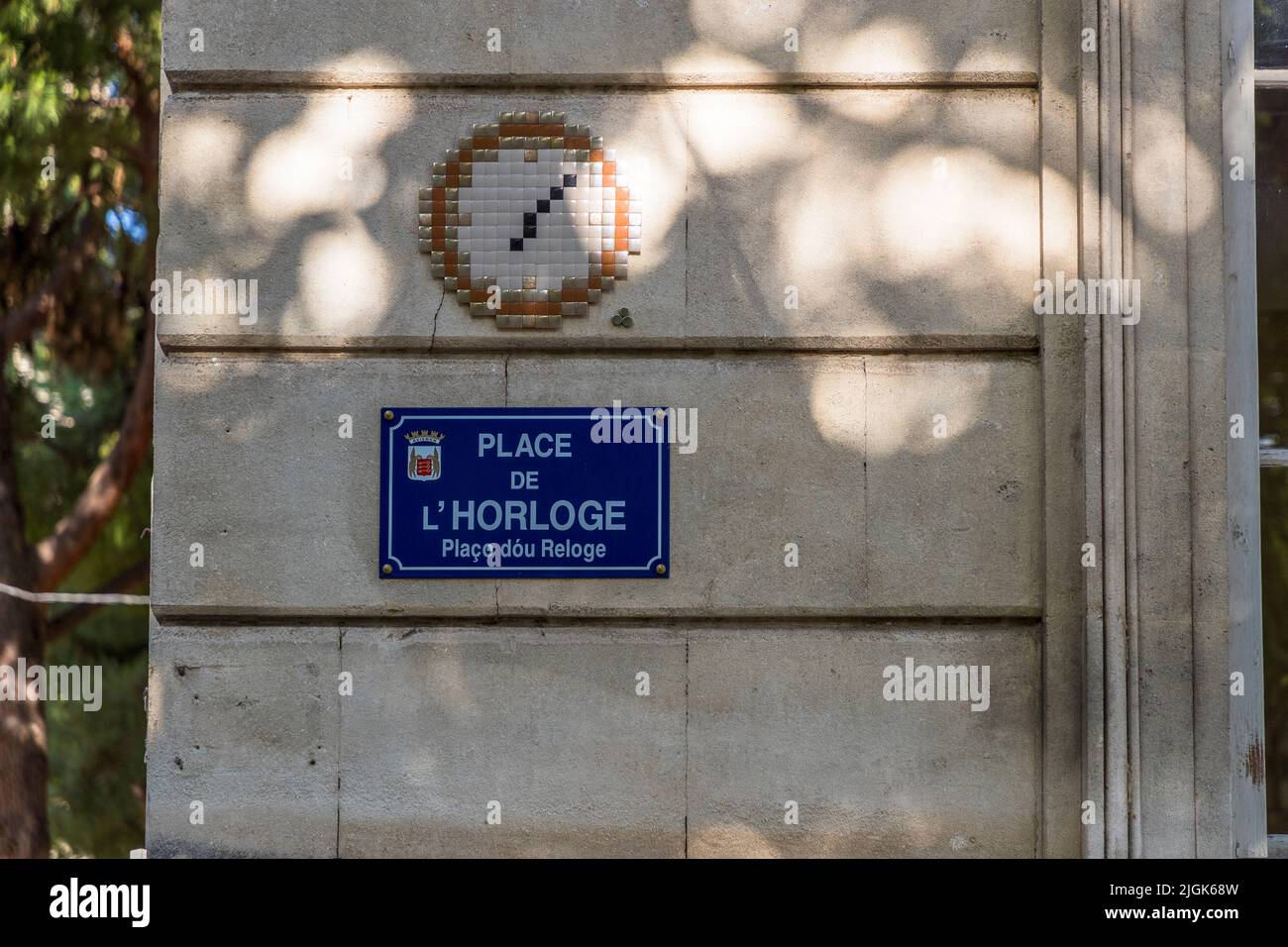 MifaMosa Place de L'Horloge, Avignon, France. The French artist peppers street signs in various cities with mosaics that have reference to the street name. As a special feature, each image has three dots pasted on it, symbolizing himself, his mother and his sister Stock Photo