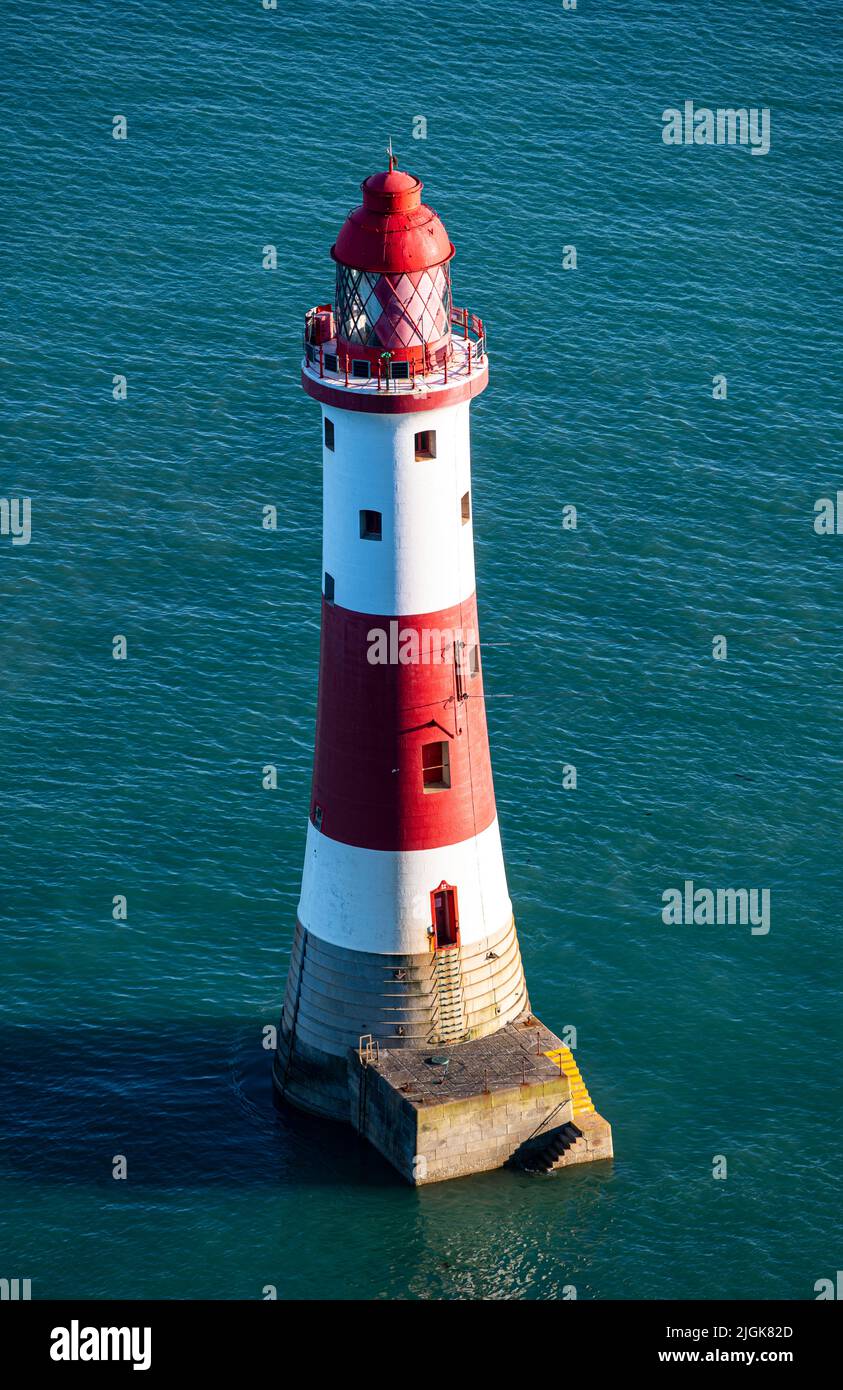 Beachy Head Lighthouse as seen at high tide in Summer late afternoon Stock Photo