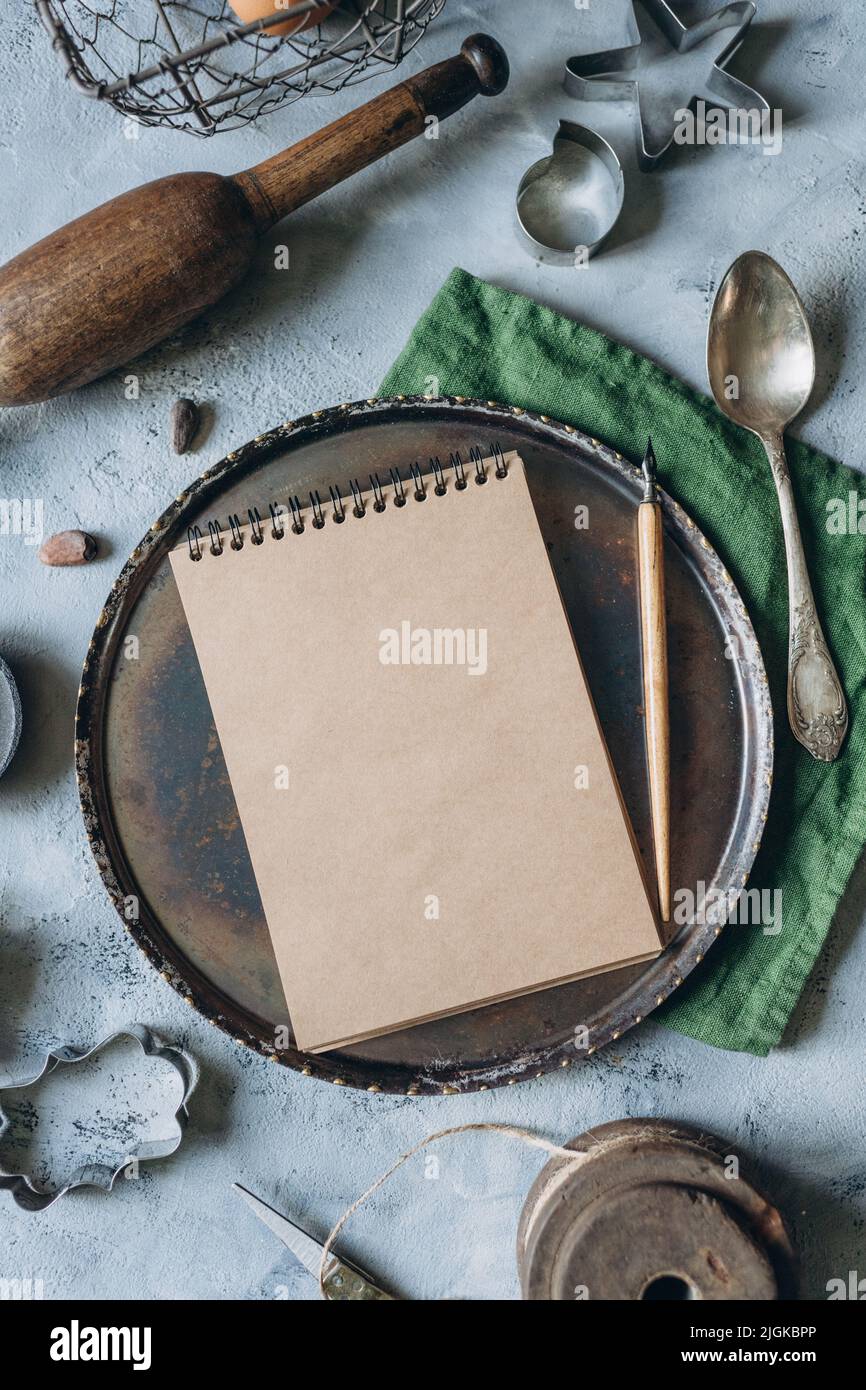 recipe book mockup on kitchen table with kitchen utensils in vintage style Stock Photo