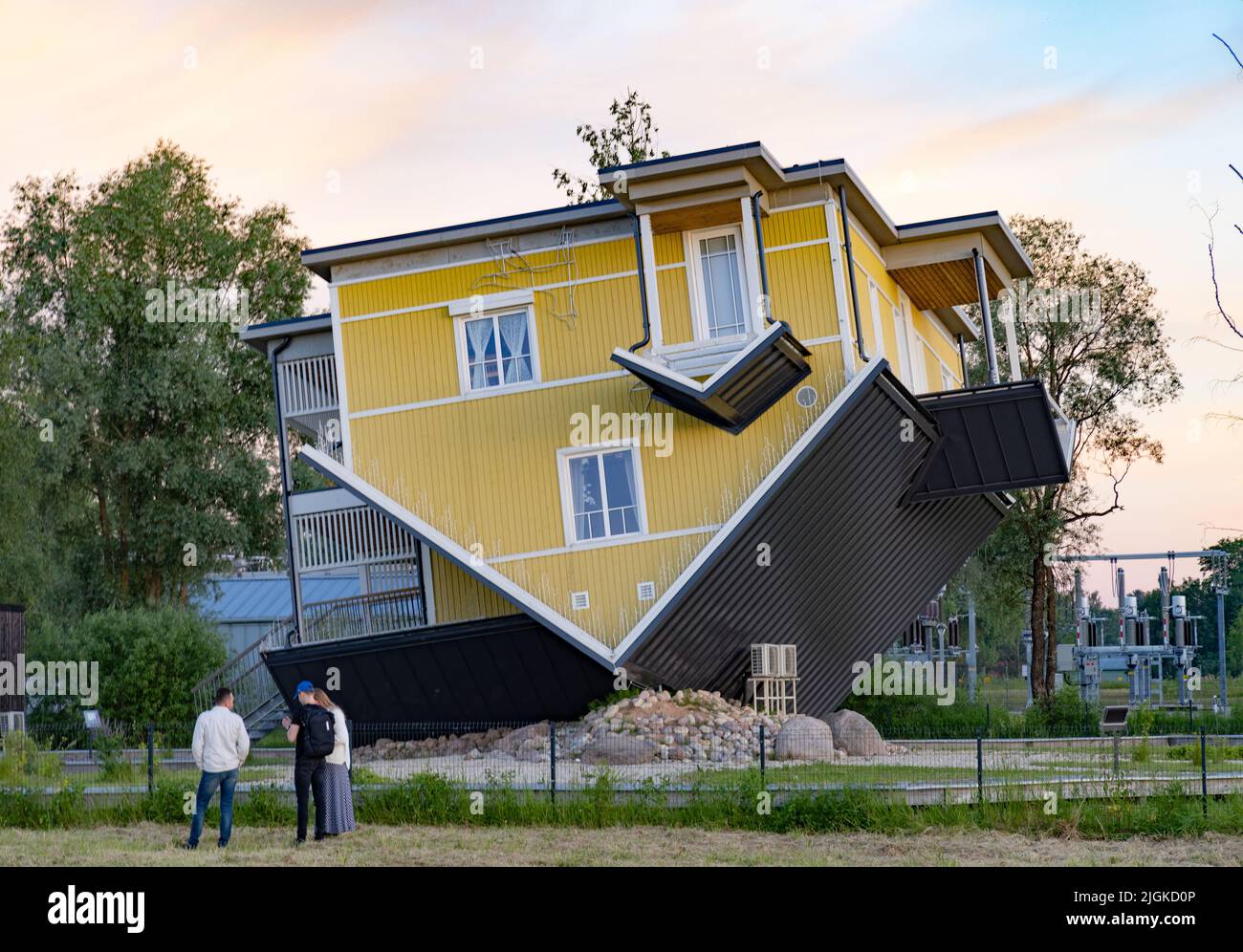 Tourists looking at The Upside down House, Tartu, Estonia Europe Stock Photo