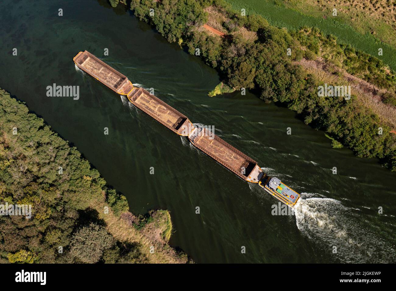 tugboat pushing empty barges for loading with sugar cane - top view Stock Photo