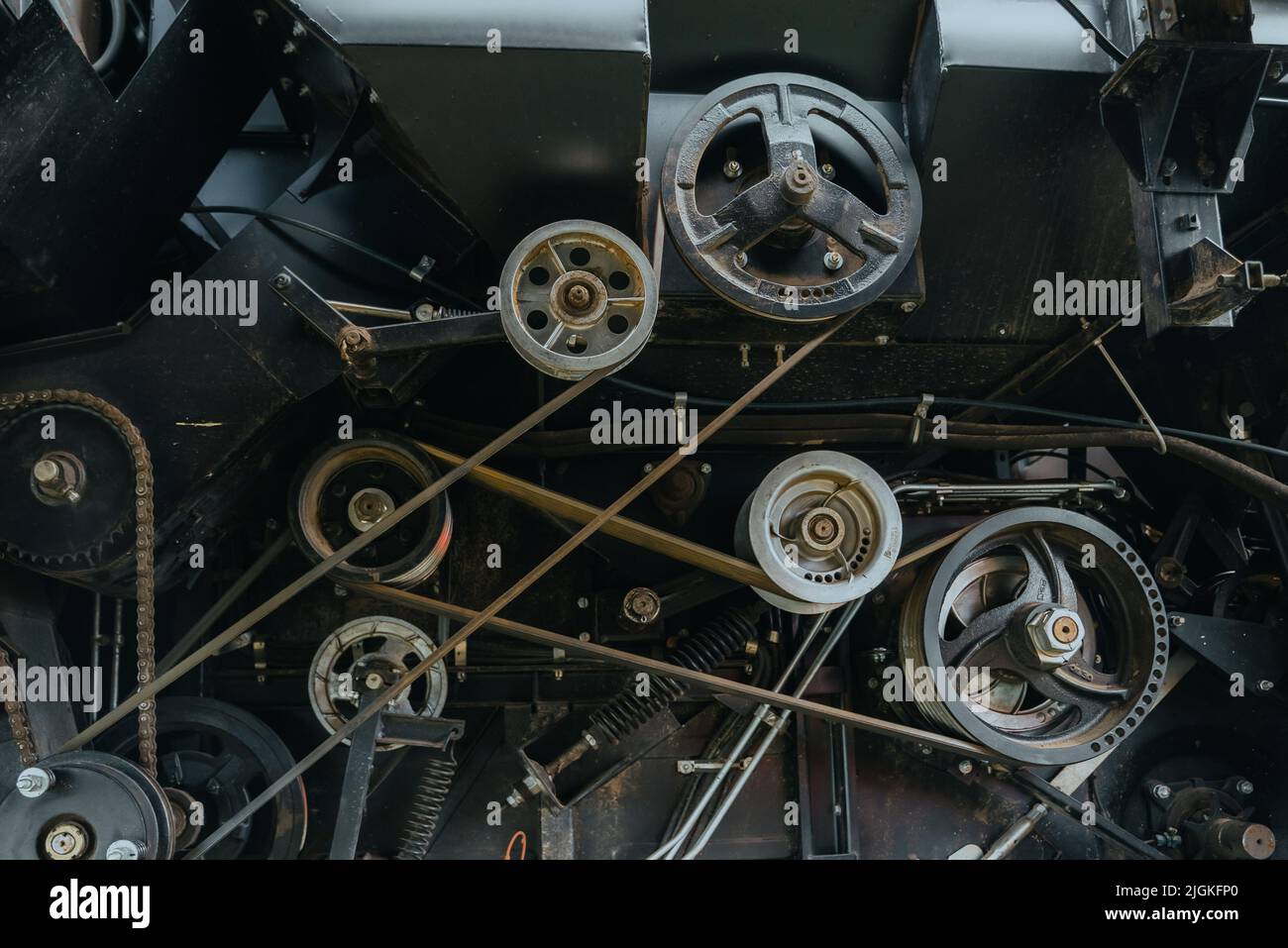 A view of the belt drive engine. Big powerful industrial combine harvester machine. Engine details. Diesel engine. Motor. Heart of the tractor. Oil machinery technology Stock Photo