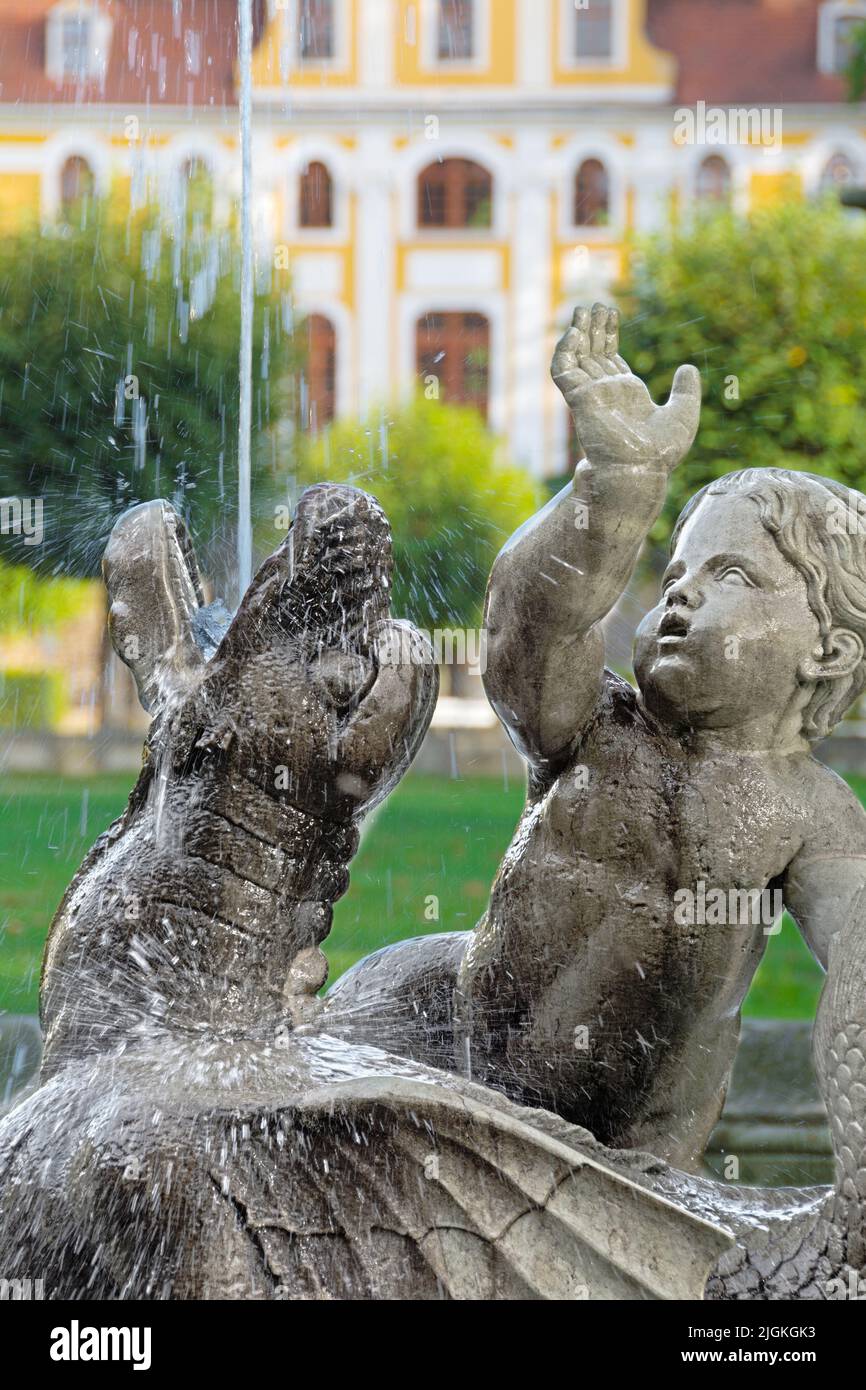 Historical fountain with baroque castle Neschwitz in the background in portrait format Stock Photo