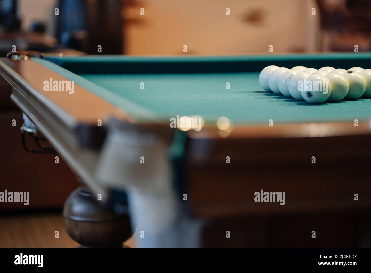 Billiard table with green surface and balls in the billiard club