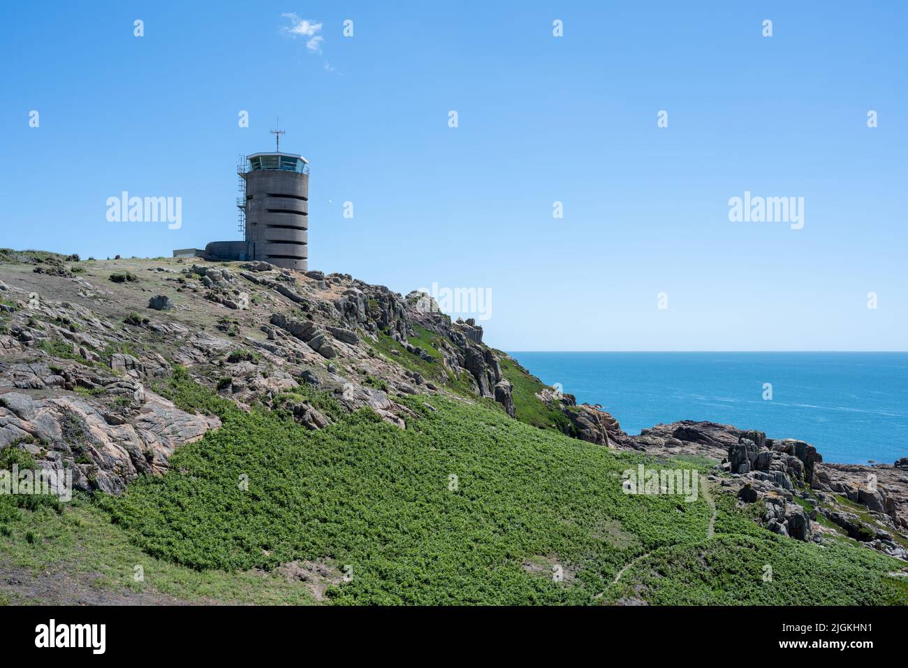 La Corbiere WW2 watchtower on the headland of St Brelade in the sout-west of the British Crown Dependency of Jersey, Channel Islands, British Isles. Stock Photo