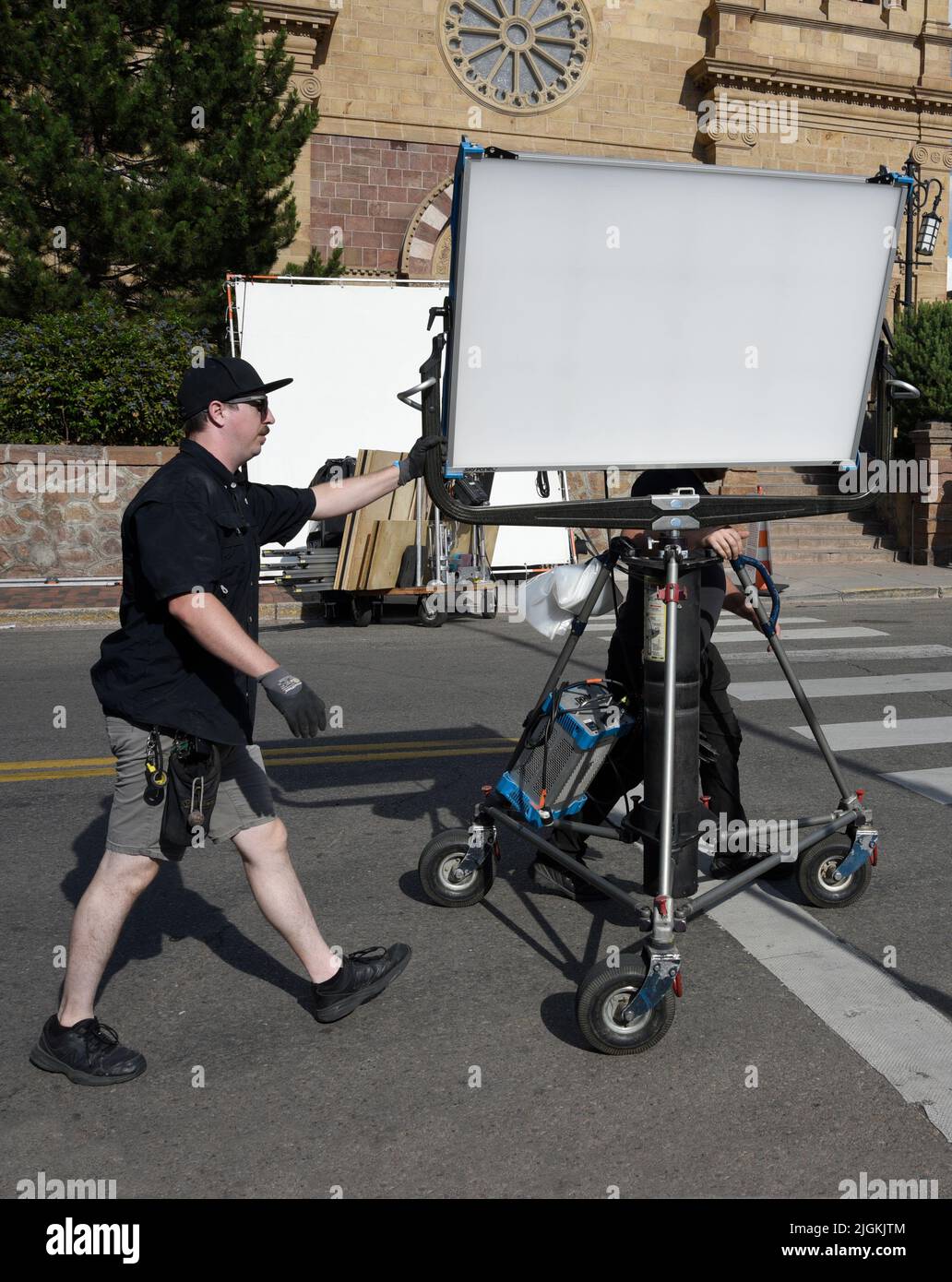 A member of a film lighting crew, a grip, moves an ARRI SkyPanel LED
