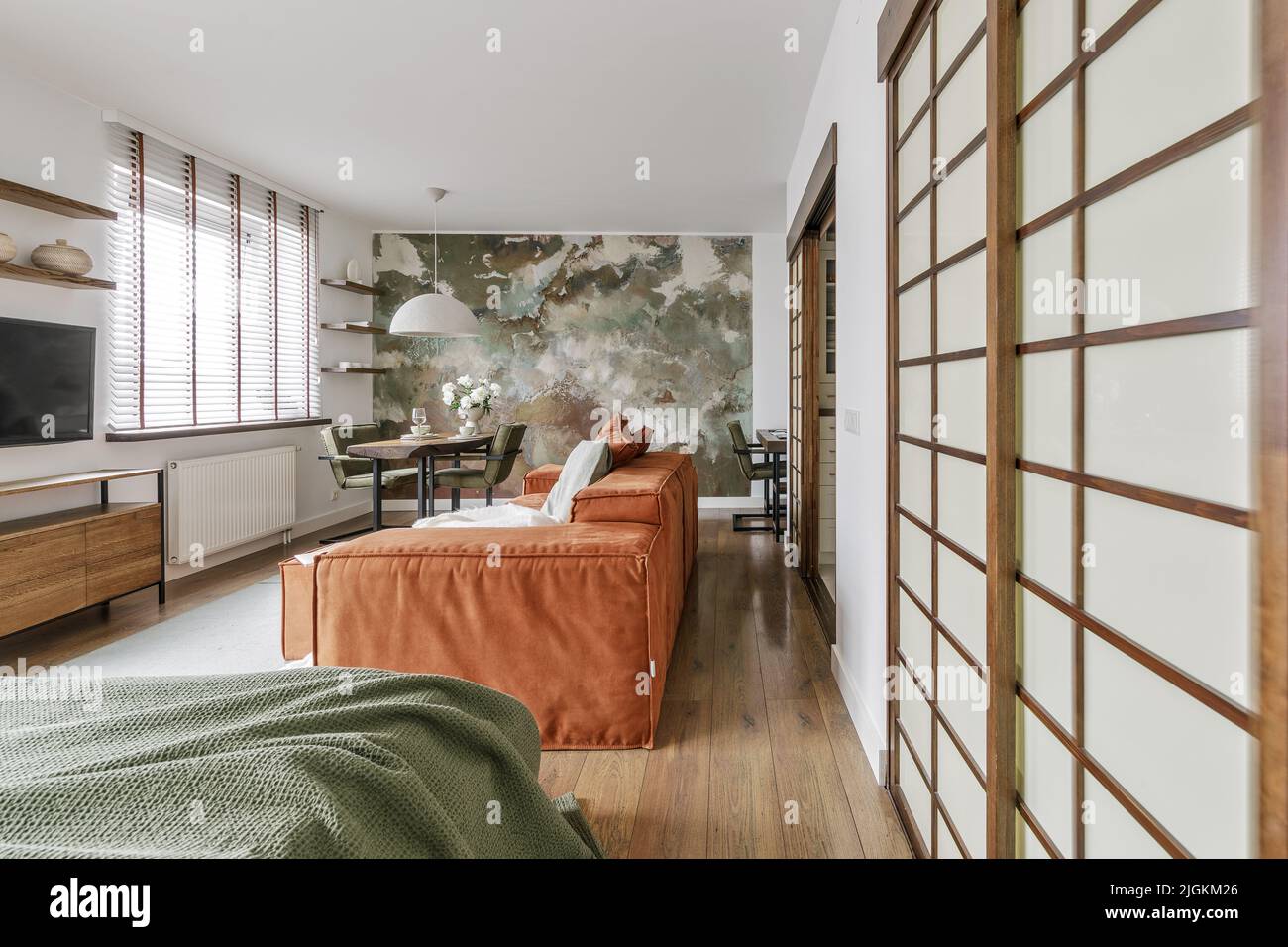 Modern Japandi interior design appartment in earth tones, natural textures with wooden solid oak furniture and sliding Japanese wood doors. Japandi co Stock Photo