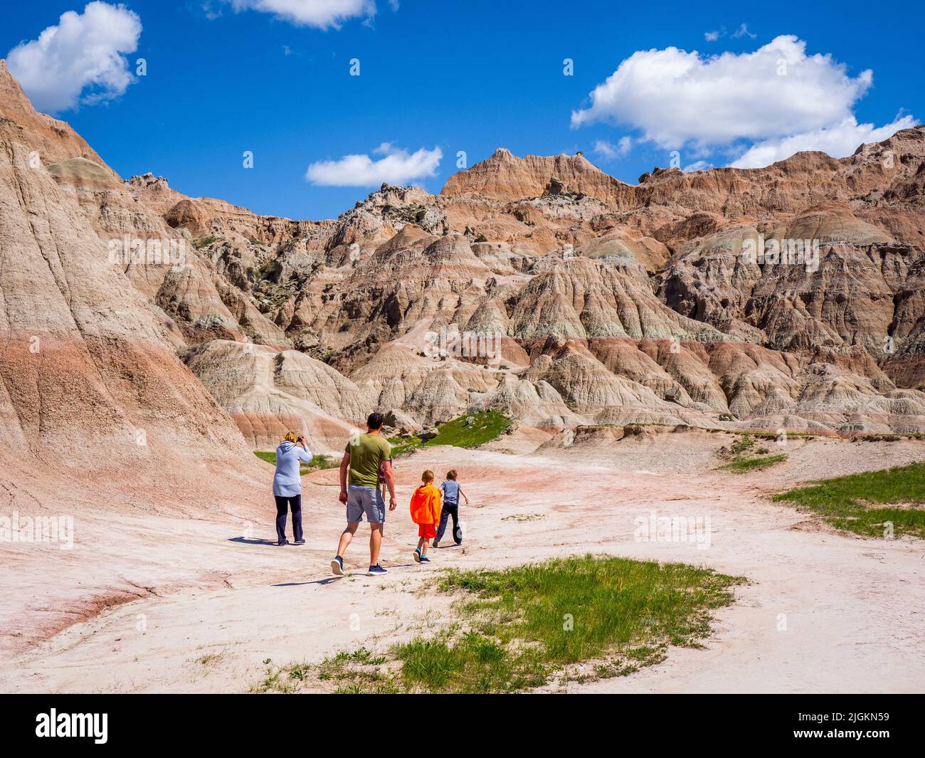 Family hiking at Saddle Pass Trailhead area of Badlands National Park in South Dakota USA Stock Photo