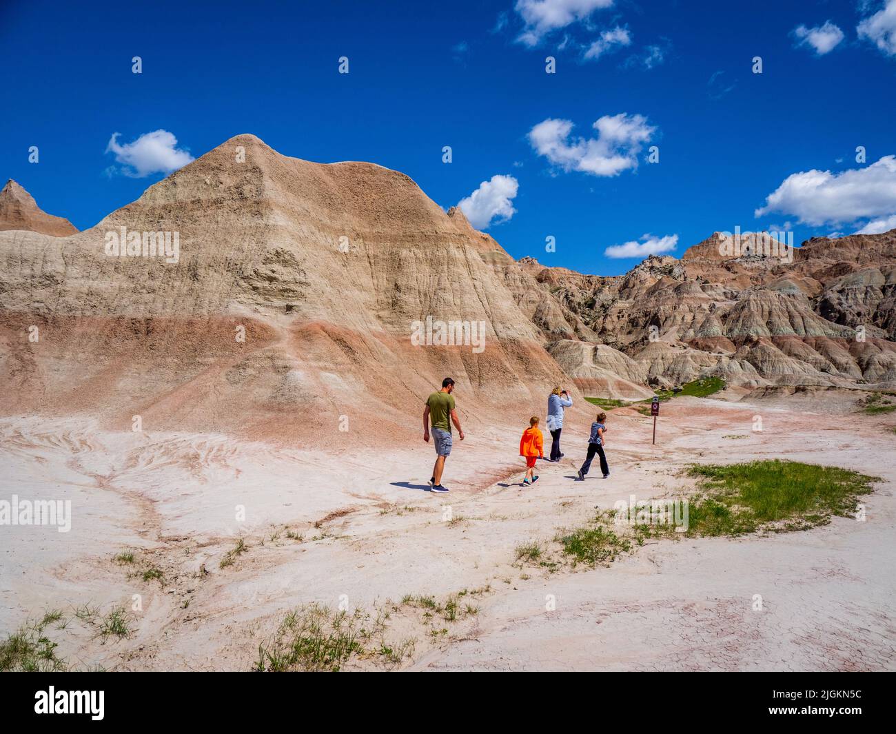 Family hiking at Saddle Pass Trailhead area of Badlands National Park in South Dakota USA Stock Photo