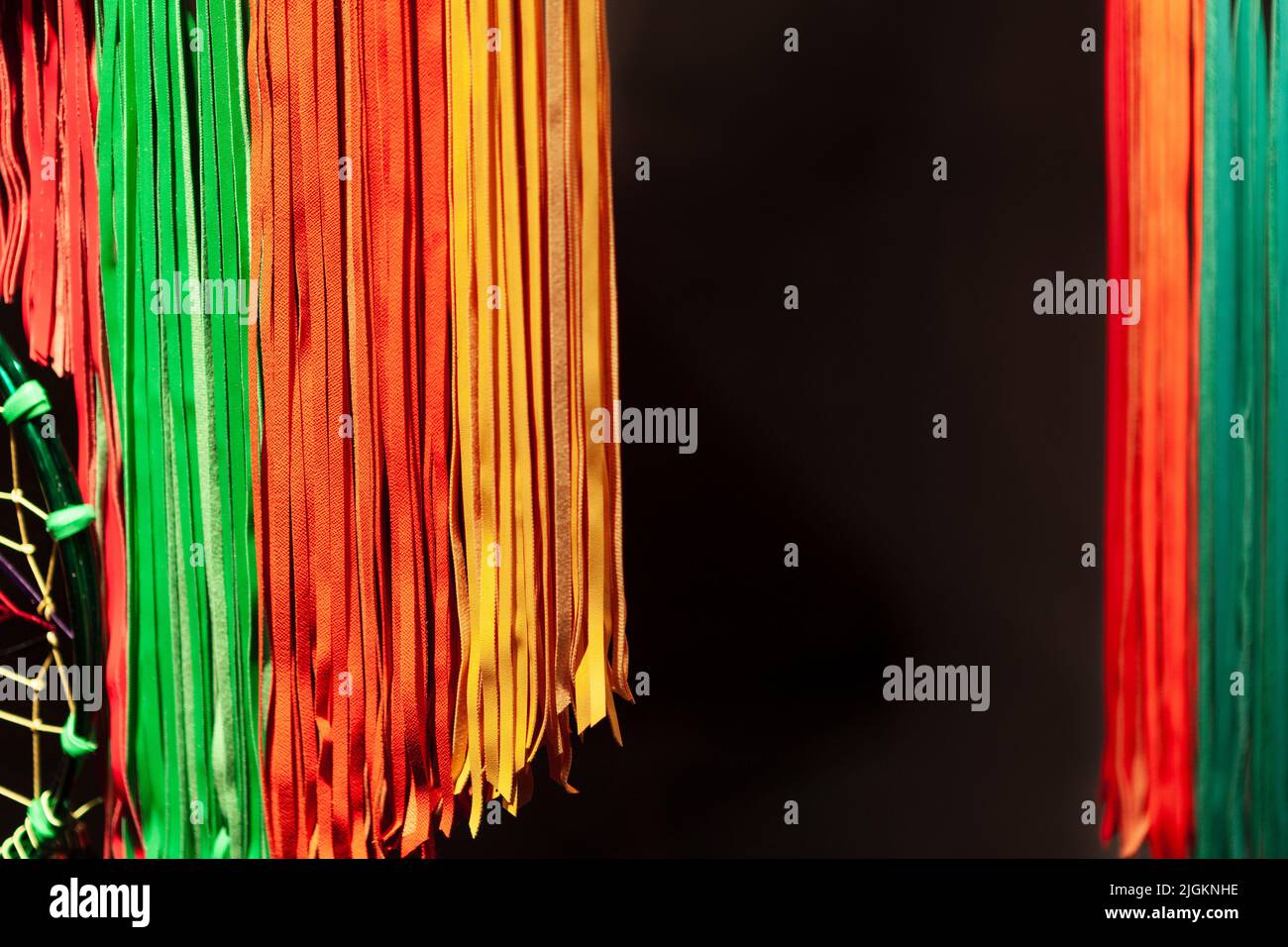 Hanging colorful ribbons at dark background Stock Photo - Alamy