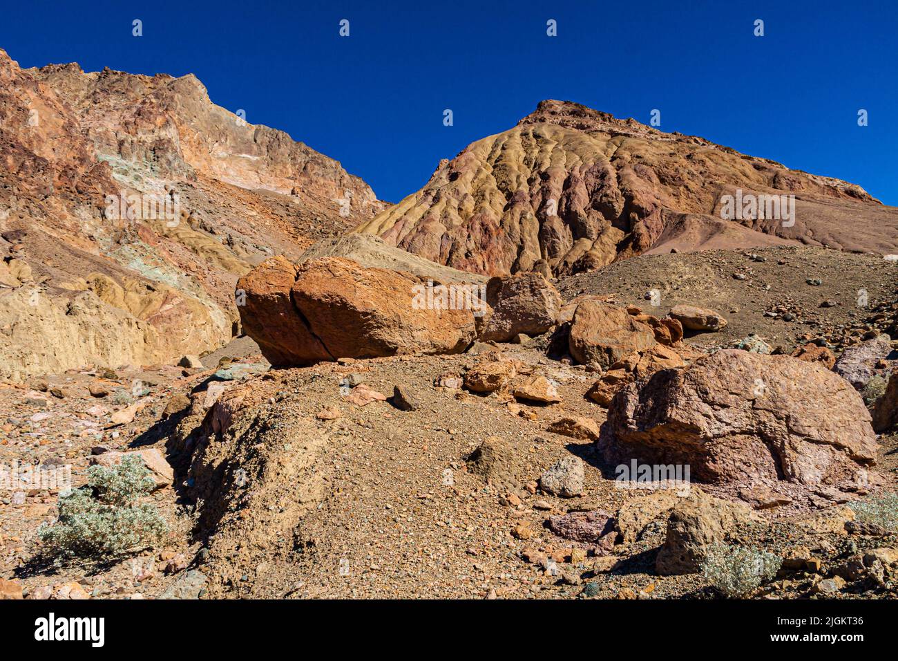 Boulders Washed Down the Alluvial Fan On the Multi-Colored Mountains of Artist's Palette, Death Valley National Park, California, USA Stock Photo