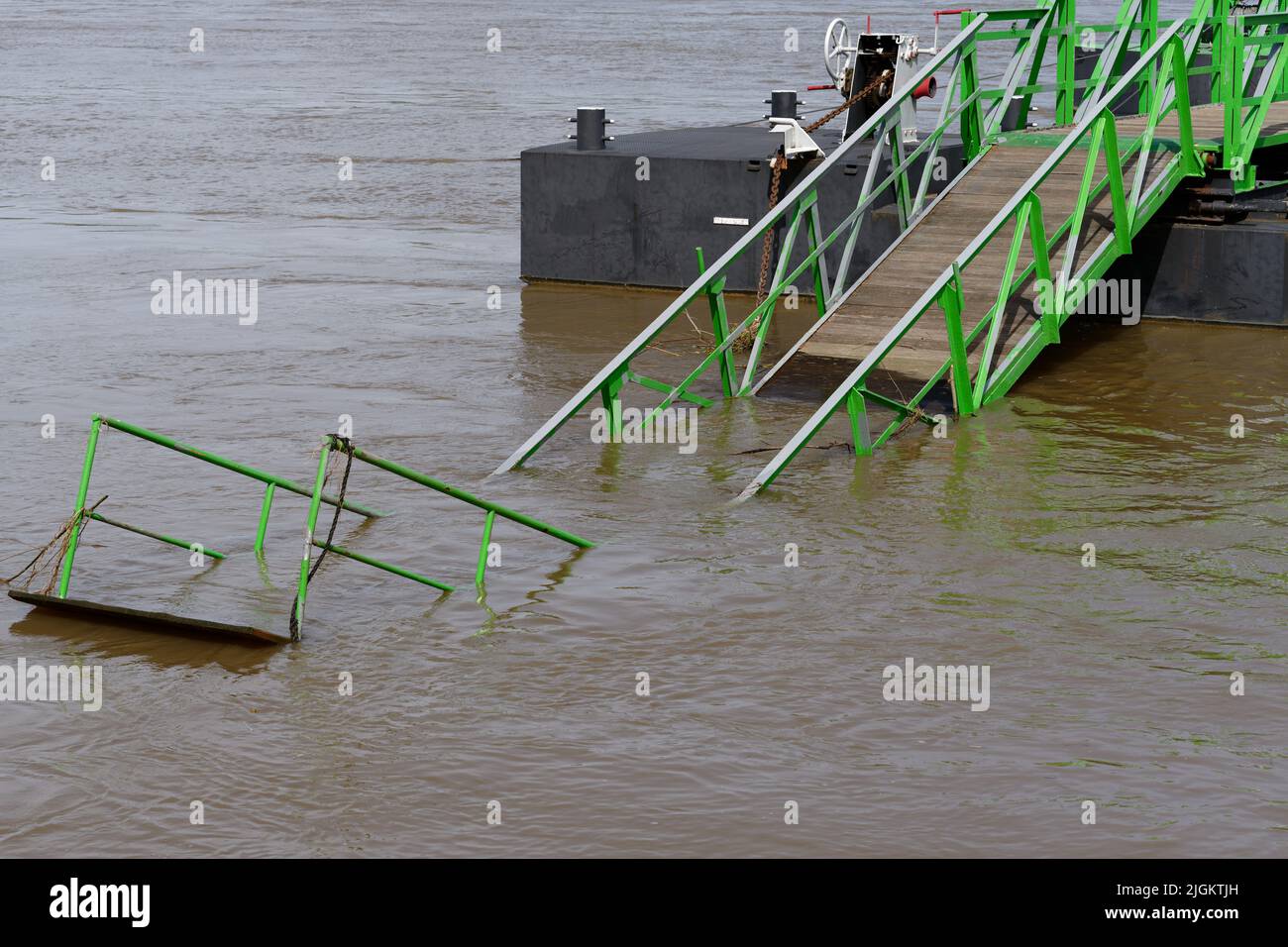 flooded damaged jetty on the rhine during high water Stock Photo